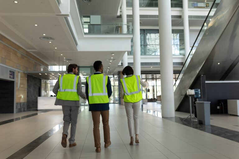 Business architect discussing over the blue print at office lobby