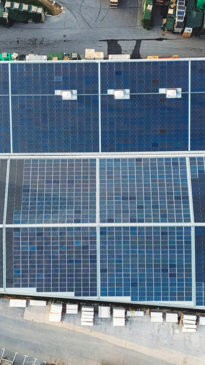 Directly above - Solar panels covering the entire roof of industrial warehouse